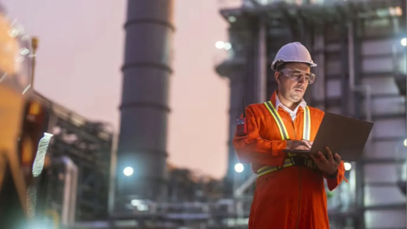 Worker with laptop in plant