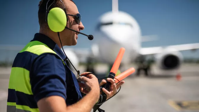 Airport worker with comm device